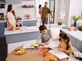 Family sitting at table in new home 